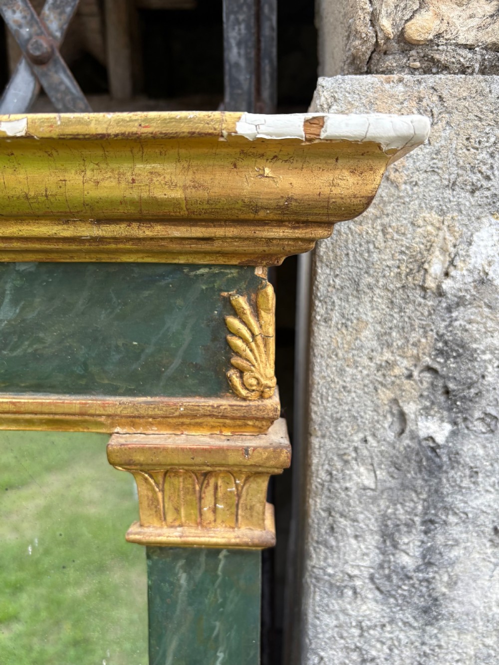 An early 19th-century Neoclassical rectangular wall mirror featuring a giltwood cornice and base flanking green faux-marble painted pilasters and frieze. View IX