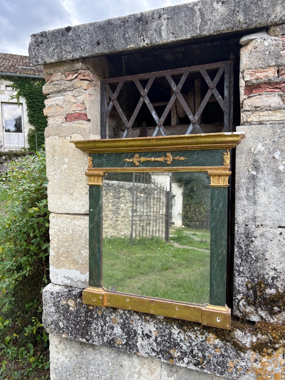 An early 19th-century Neoclassical rectangular wall mirror featuring a giltwood cornice and base flanking green faux-marble painted pilasters and frieze. View XVII