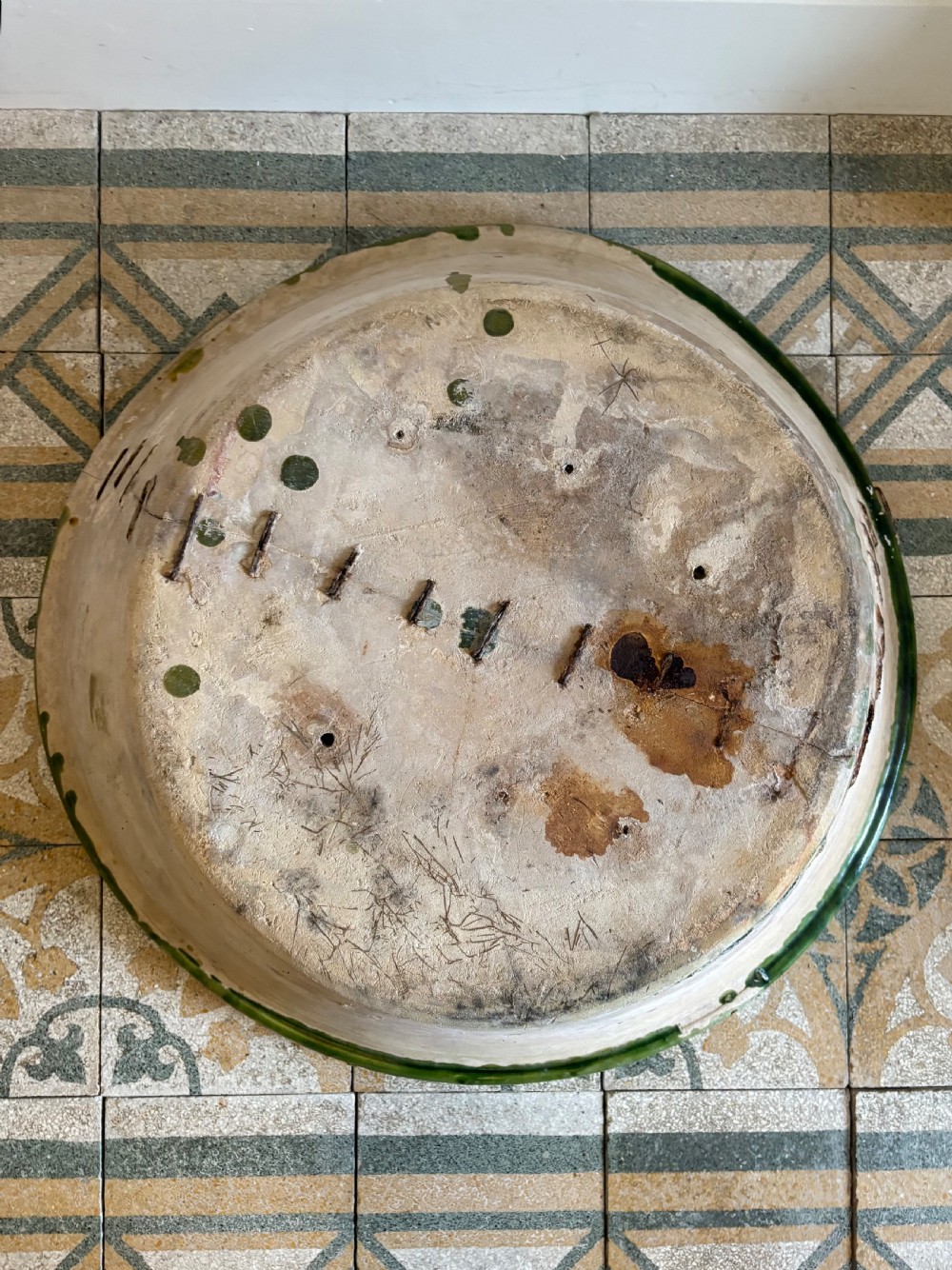 A large 19th-century French earthenware tian bowl featuring an unglazed cream exterior with historical iron staple repairs and a green-glazed interior. View X