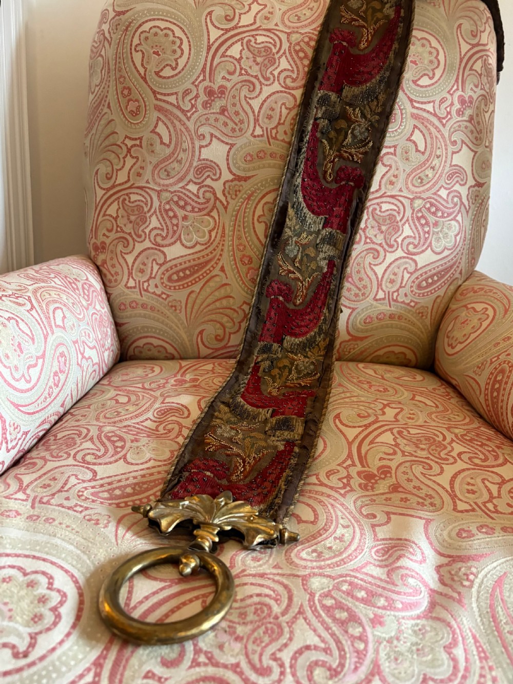 A long 19th-century hand-embroidered silk and beadwork bell pull featuring floral designs and cast brass end fittings with a lower ring. View II