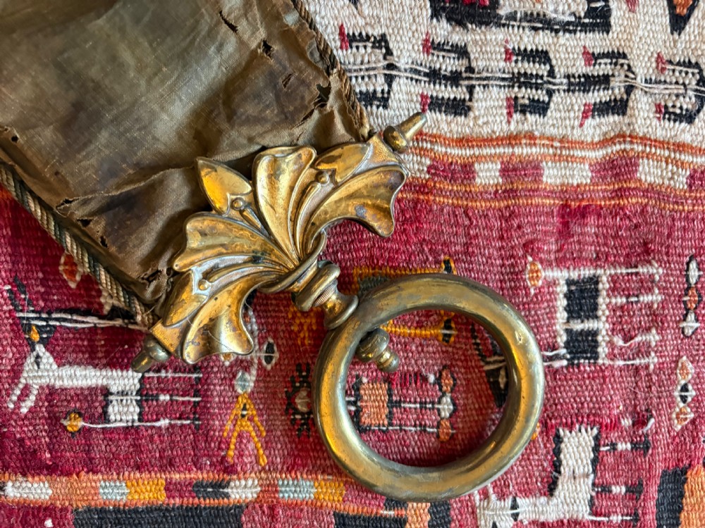 A long 19th-century hand-embroidered silk and beadwork bell pull featuring floral designs and cast brass end fittings with a lower ring. View V