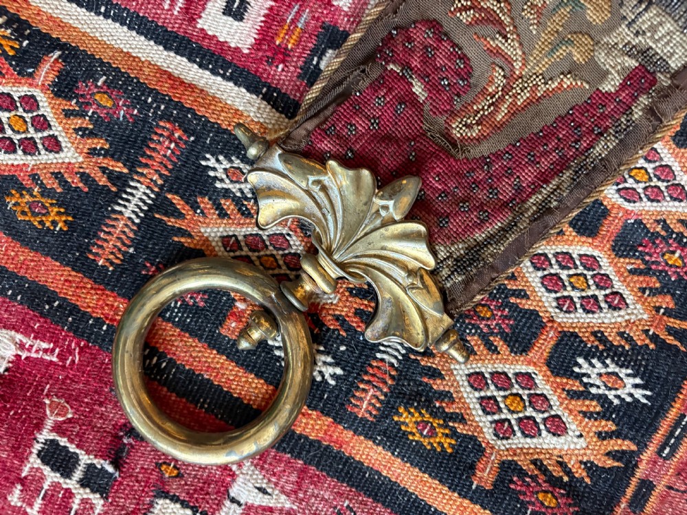A long 19th-century hand-embroidered silk and beadwork bell pull featuring floral designs and cast brass end fittings with a lower ring. View XI