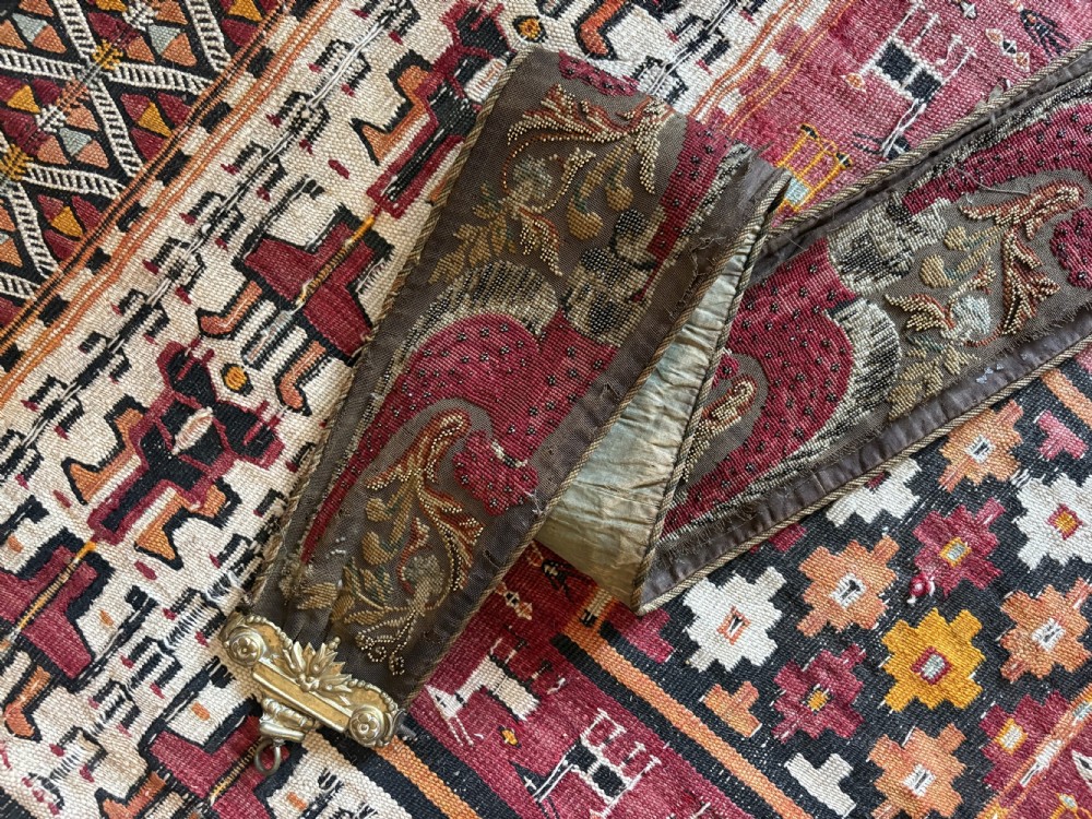 A long 19th-century hand-embroidered silk and beadwork bell pull featuring floral designs and cast brass end fittings with a lower ring. View XVII
