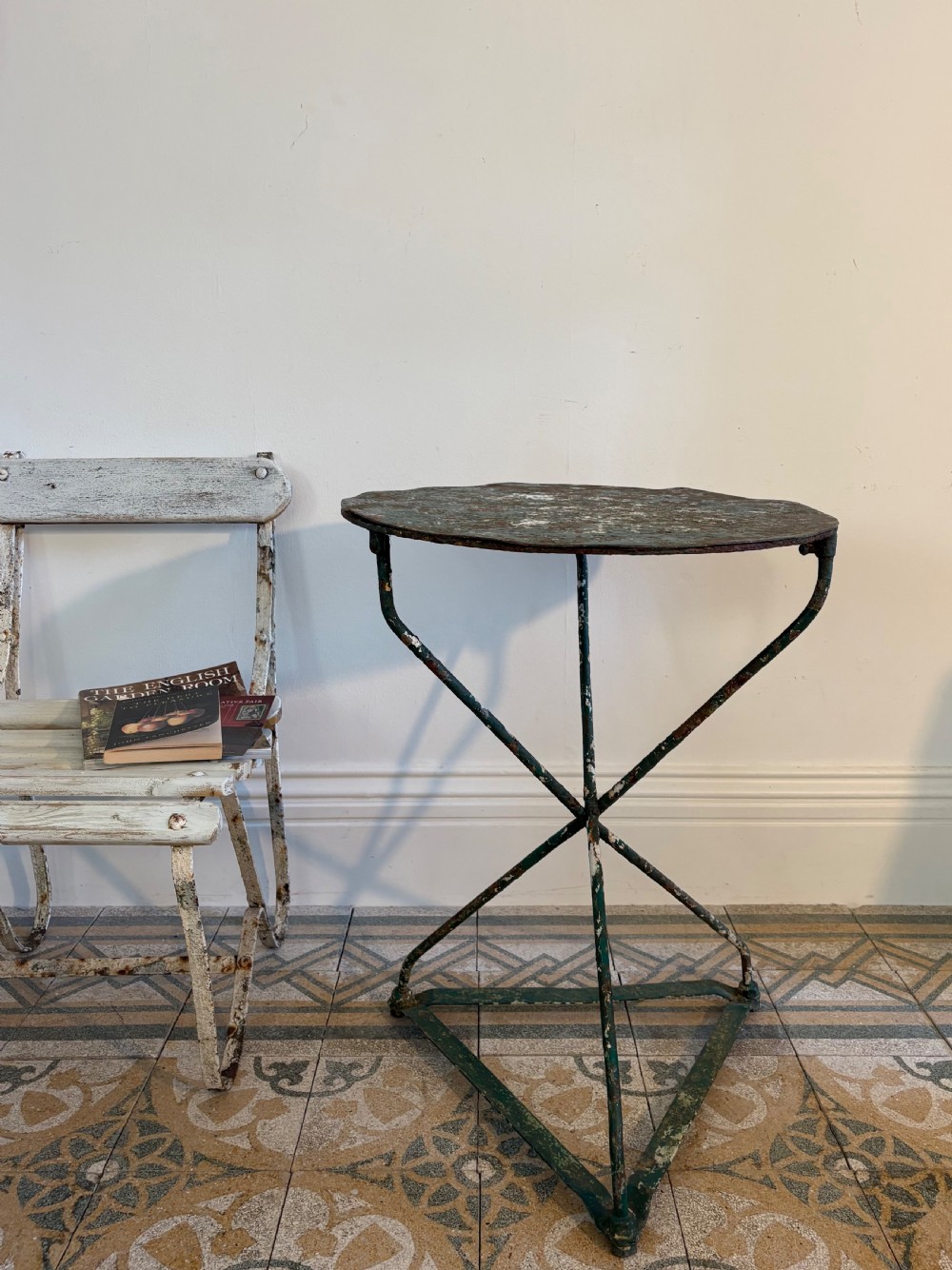 A 19th-century French cast iron gueridon round table featuring distressed green paint and a triangular tripod base. View II