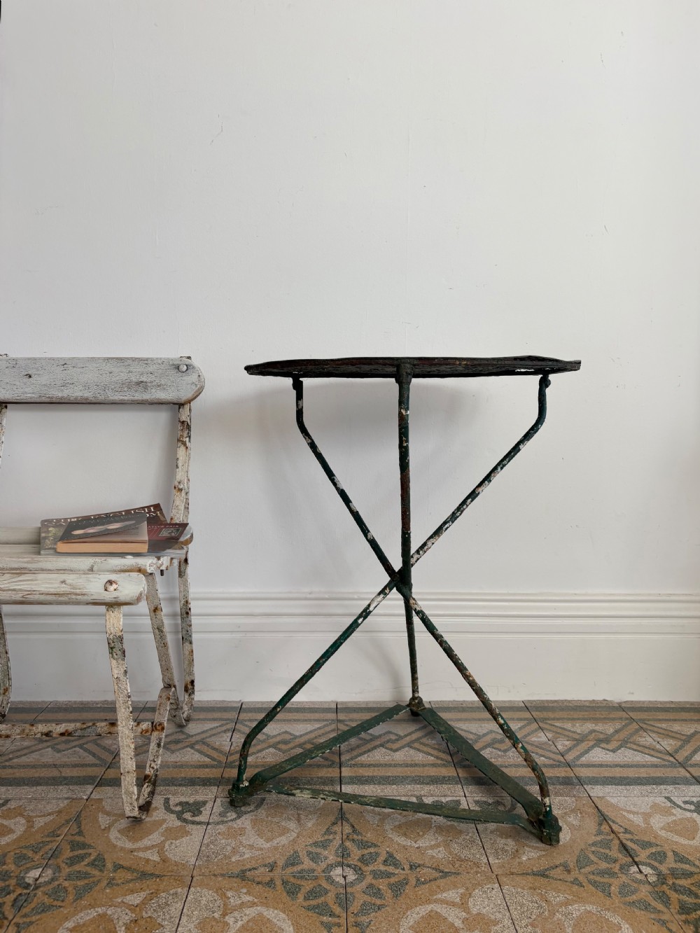 A 19th-century French cast iron gueridon round table featuring distressed green paint and a triangular tripod base. View IX