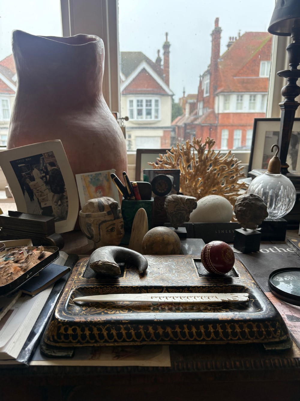 A rectangular hand-painted black and gold Kashmiri papier-mache inkstand featuring two square inkwell recesses and a long pen tray. View XVIII