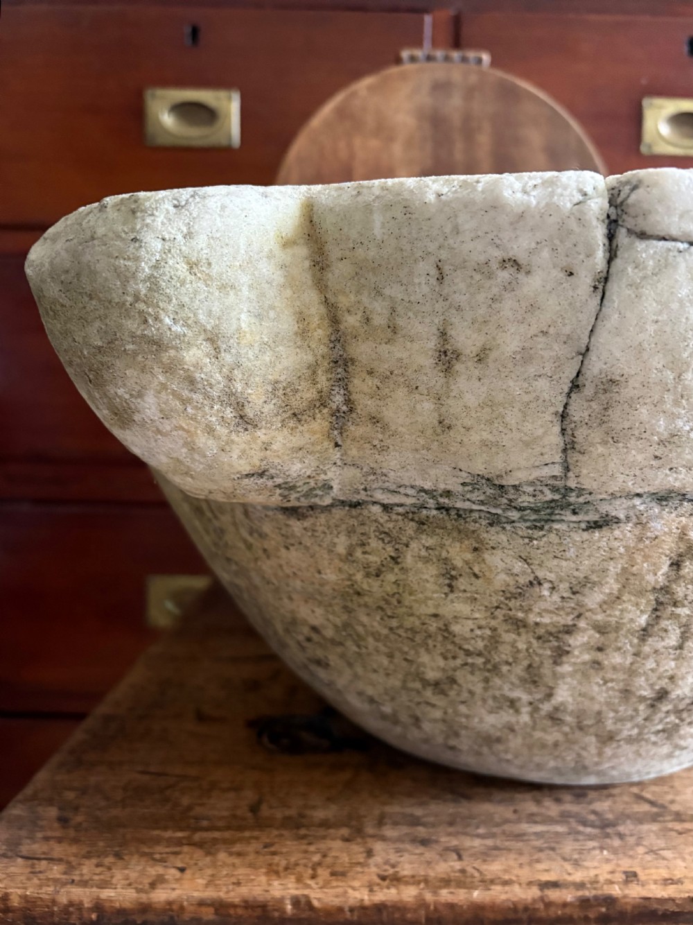 A large 18th-century carved white marble mortar featuring four thick corner lugs and a weathered, textured outer surface. View IX