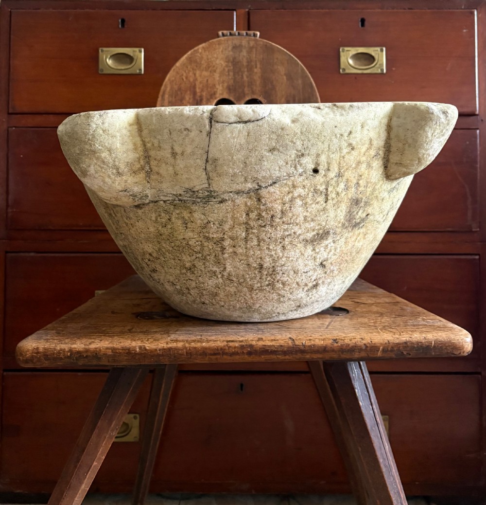 A large 18th-century carved white marble mortar featuring four thick corner lugs and a weathered, textured outer surface. View XI