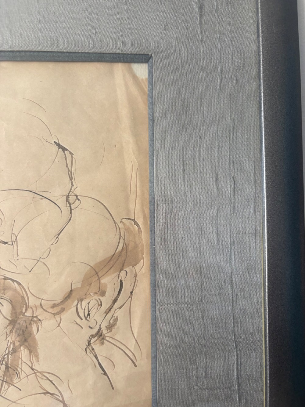 A framed 19th-century sepia pen and ink preparatory drawing depicting expressively sketched head studies on aged paper. View V