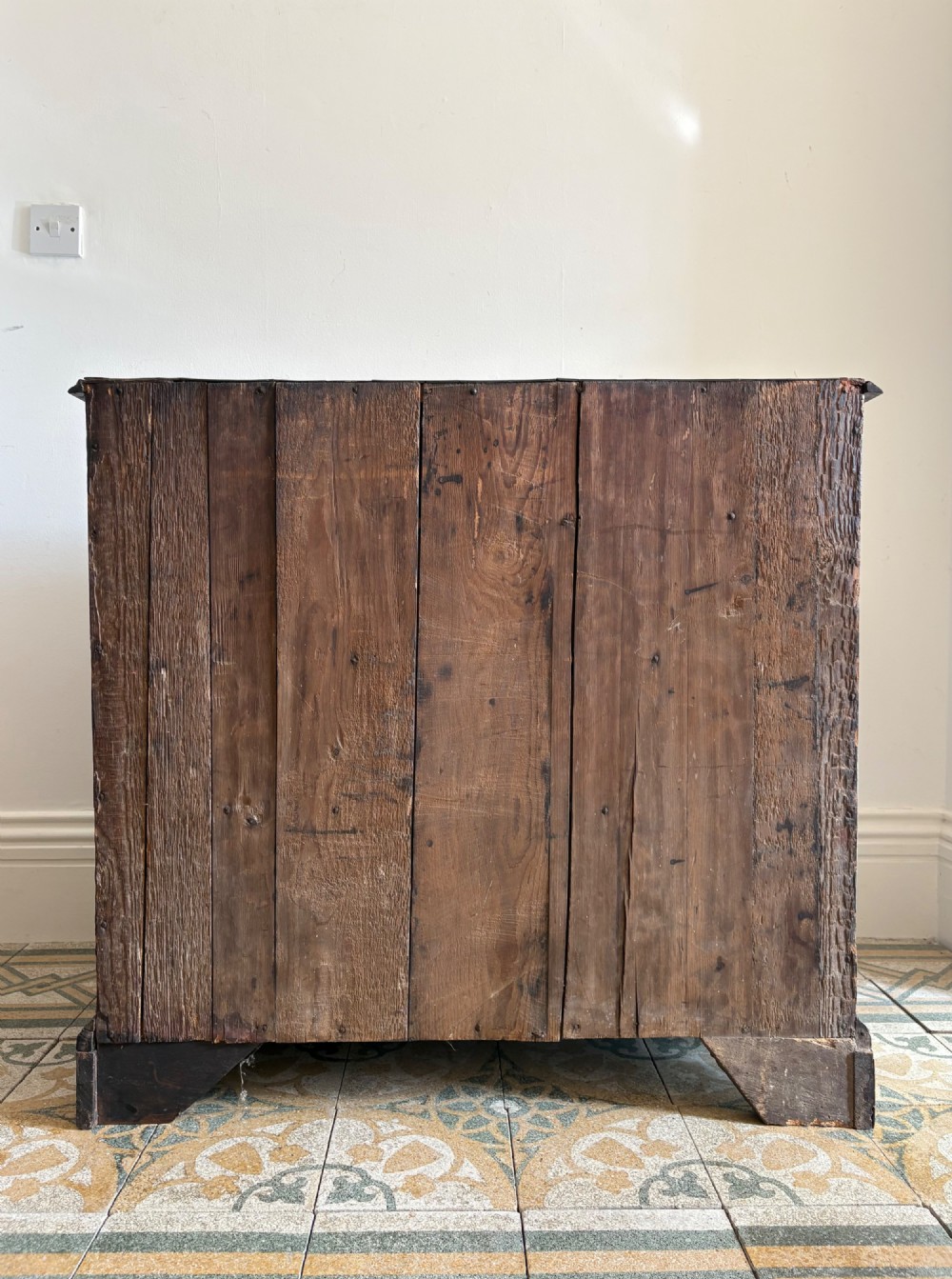 A mid-18th-century Georgian walnut chest of drawers featuring a two-over-three drawer layout, brass handles with backplates, and bracket feet. View II