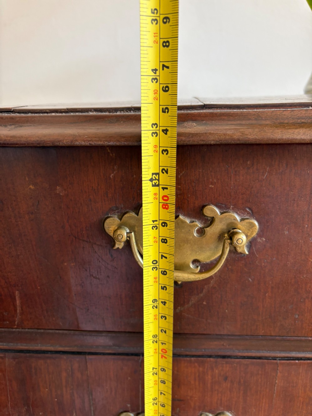 A mid-18th-century Georgian walnut chest of drawers featuring a two-over-three drawer layout, brass handles with backplates, and bracket feet. View XV