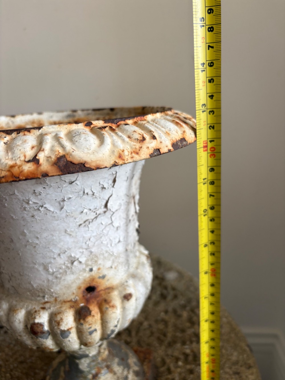 A pair of 19th-century classical cast iron garden urns featuring distressed flaking white paint, fluted bowls, and square bases. View XI