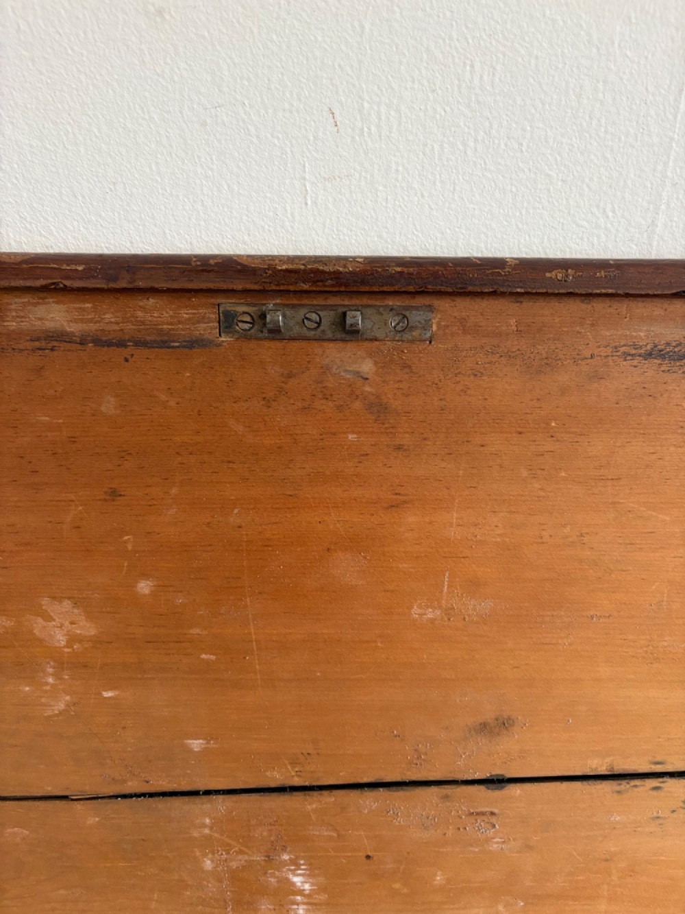 A 19th-century rectangular pine trunk featuring decorative scumble glazed painted panels, a hinged lid, and turned bun feet. View VII