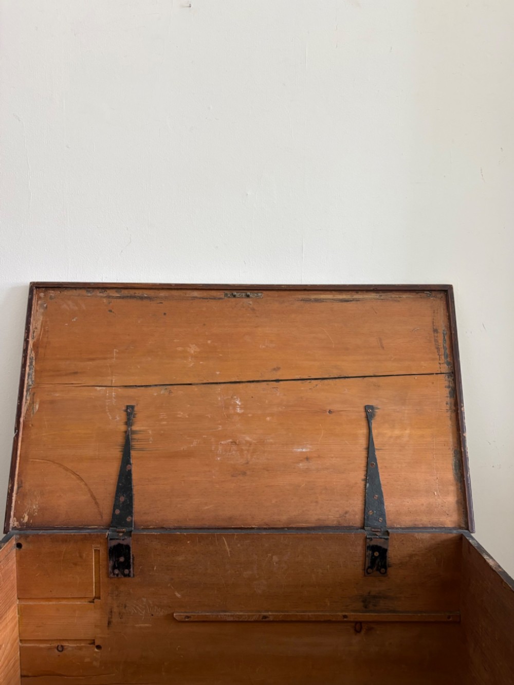 A 19th-century rectangular pine trunk featuring decorative scumble glazed painted panels, a hinged lid, and turned bun feet. View VIII