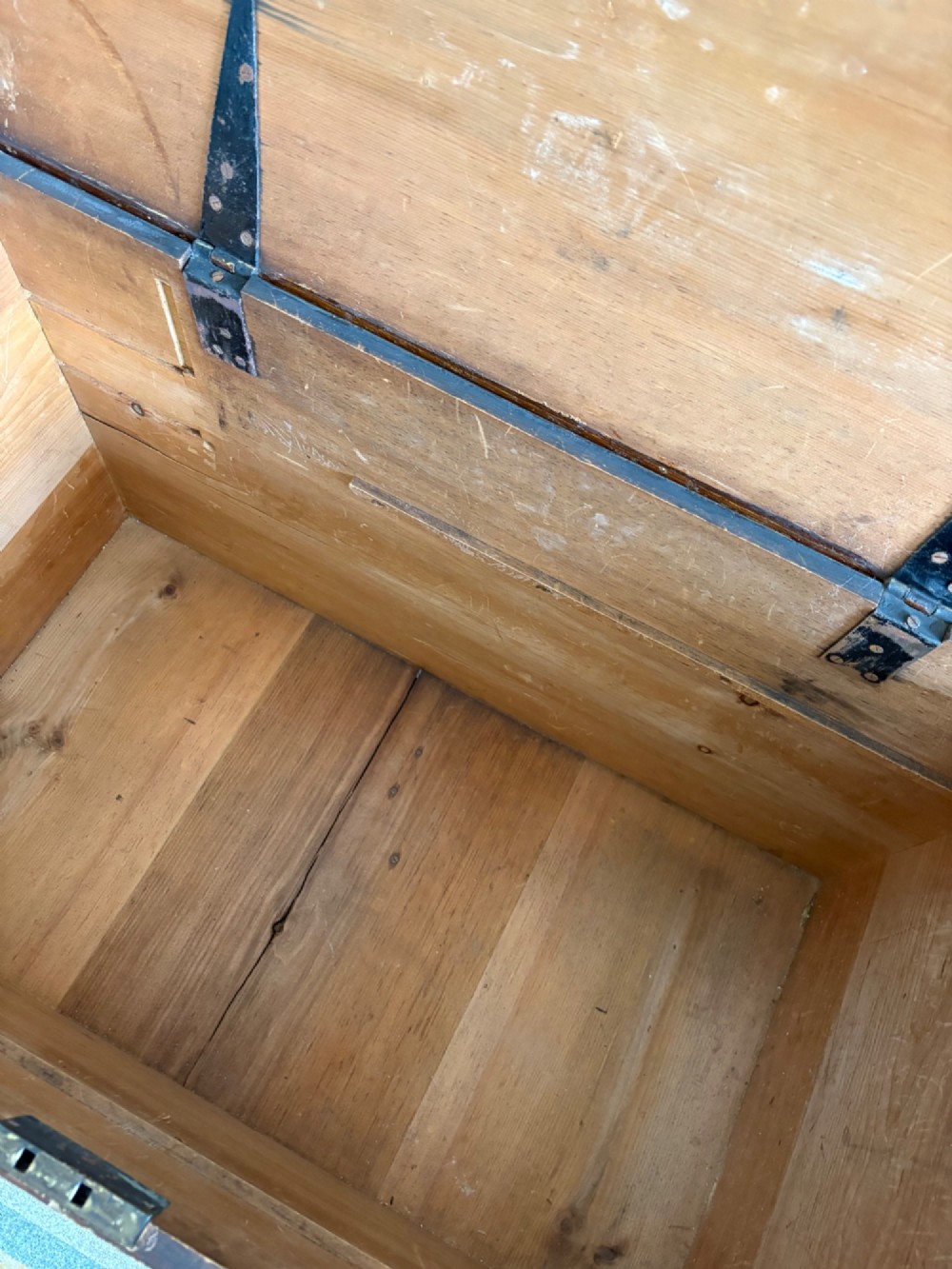 A 19th-century rectangular pine trunk featuring decorative scumble glazed painted panels, a hinged lid, and turned bun feet. View IX