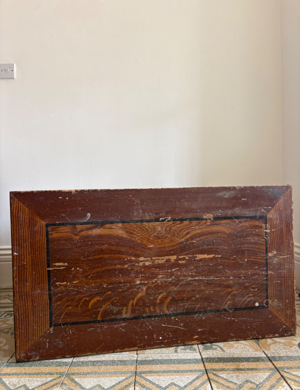 A 19th-century rectangular pine trunk featuring decorative scumble glazed painted panels, a hinged lid, and turned bun feet. View XII