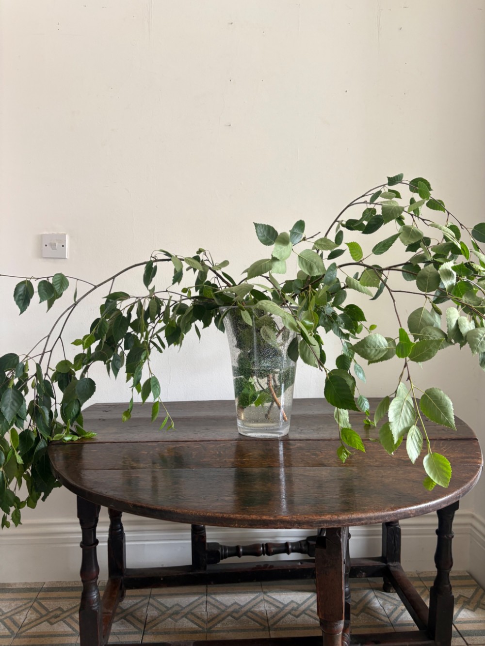 A dark oak gateleg table with a drop-leaf plank top and turned baluster legs joined by low stretchers. View VII