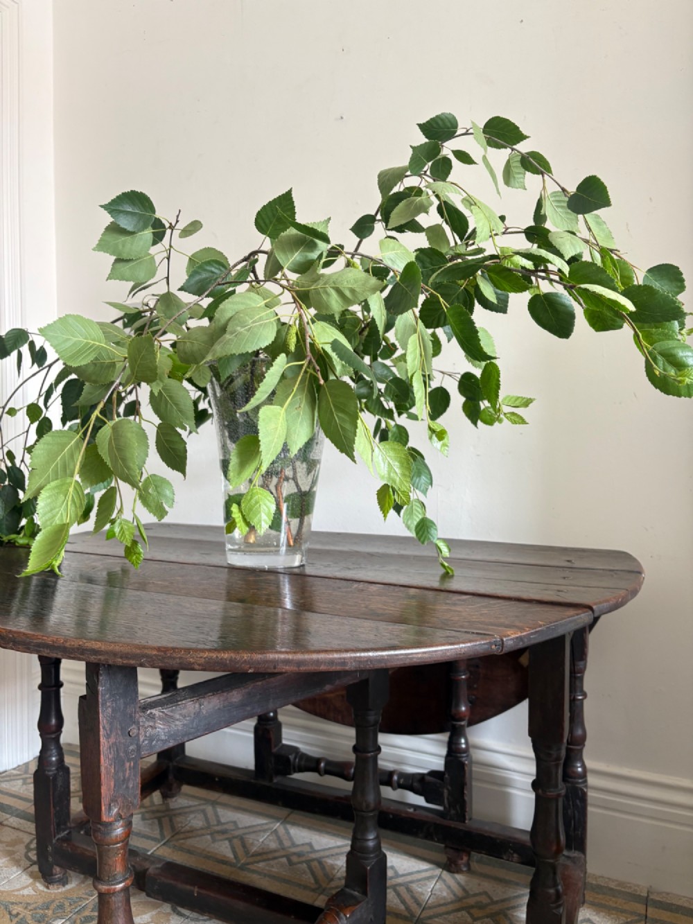 A dark oak gateleg table with a drop-leaf plank top and turned baluster legs joined by low stretchers. View VIII