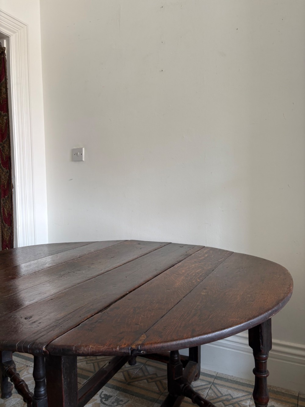 A dark oak gateleg table with a drop-leaf plank top and turned baluster legs joined by low stretchers. View XIII
