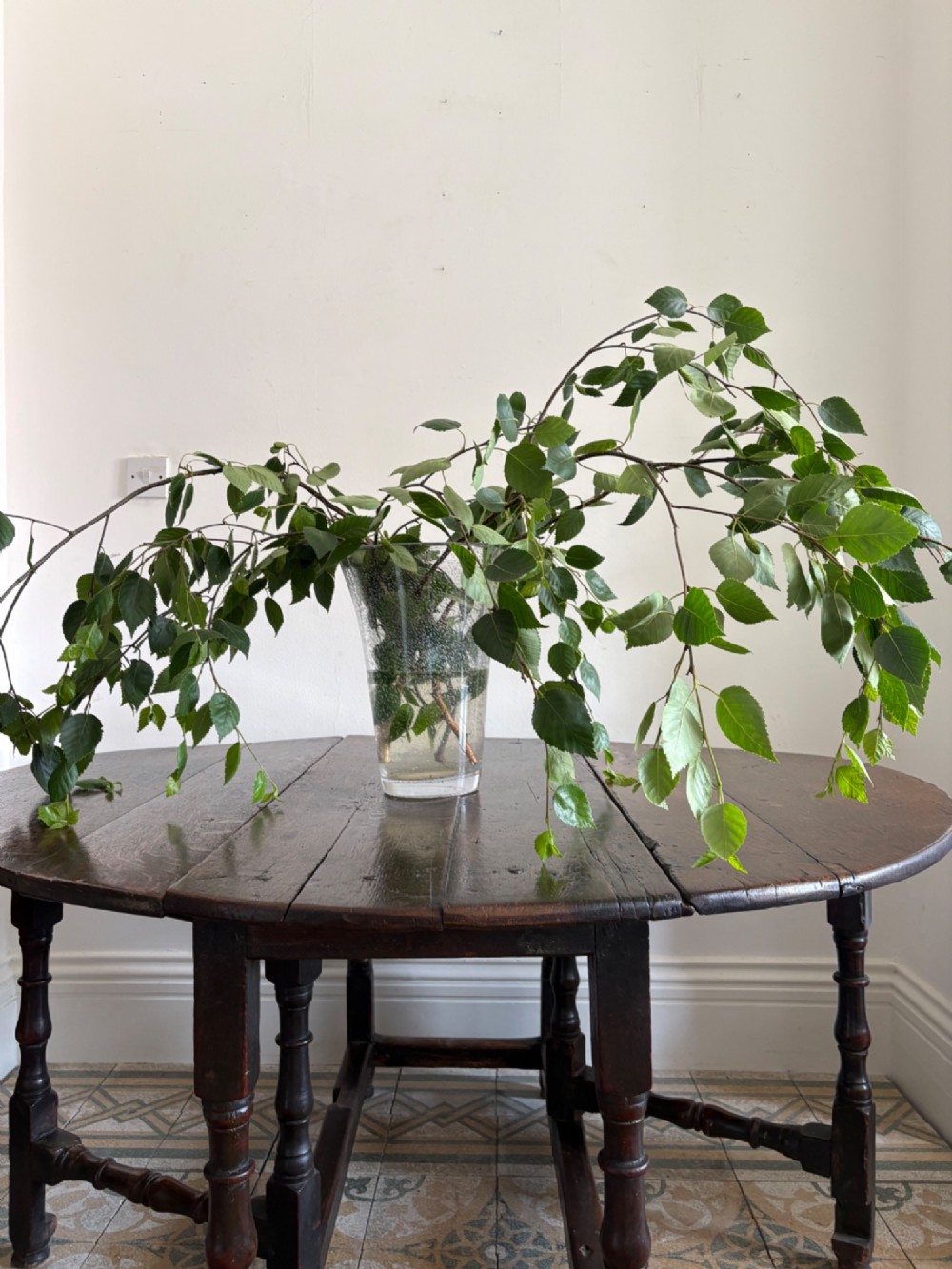 A dark oak gateleg table with a drop-leaf plank top and turned baluster legs joined by low stretchers. View XIV