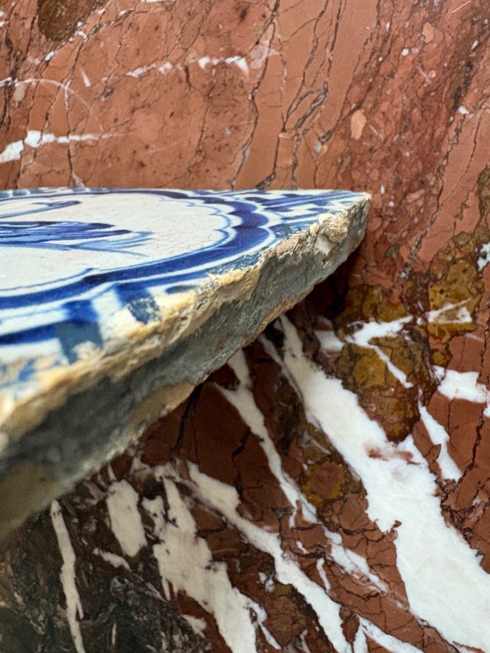 A square 17th-century tin-glazed earthenware tile featuring a hand-painted cobalt blue swan motif inside a scalloped border with geometric corner details. View VIII