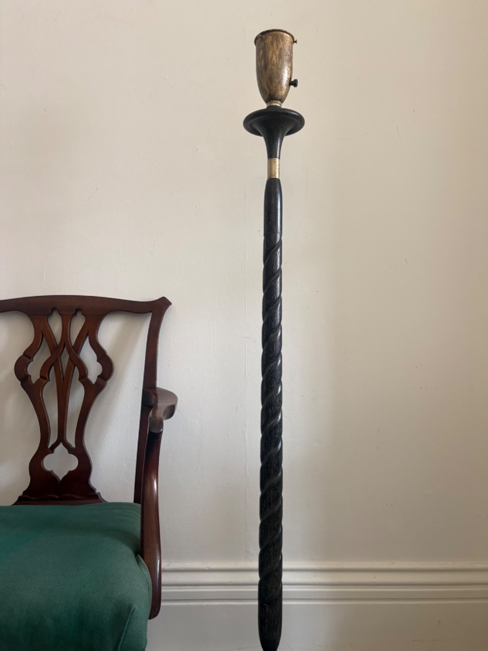 A French 1920s ebonised floor lamp featuring a carved barley twist column on a square base with a brass socket fitting. View II