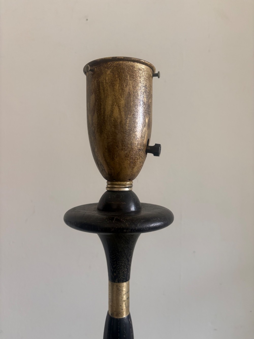 A French 1920s ebonised floor lamp featuring a carved barley twist column on a square base with a brass socket fitting. View IV