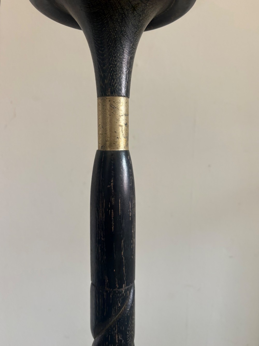 A French 1920s ebonised floor lamp featuring a carved barley twist column on a square base with a brass socket fitting. View V