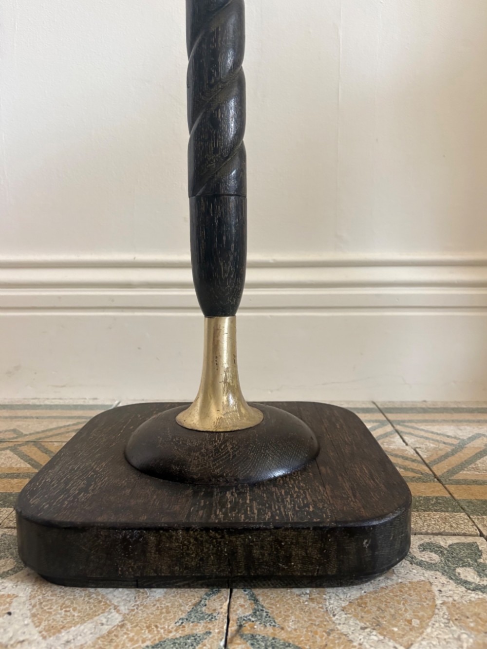 A French 1920s ebonised floor lamp featuring a carved barley twist column on a square base with a brass socket fitting. View VI