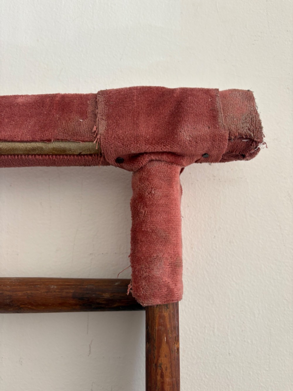 A tall early 20th-century pitch pine and elm library ladder with turned wooden rungs and a padded upper rail leaning against a white wall. View IX