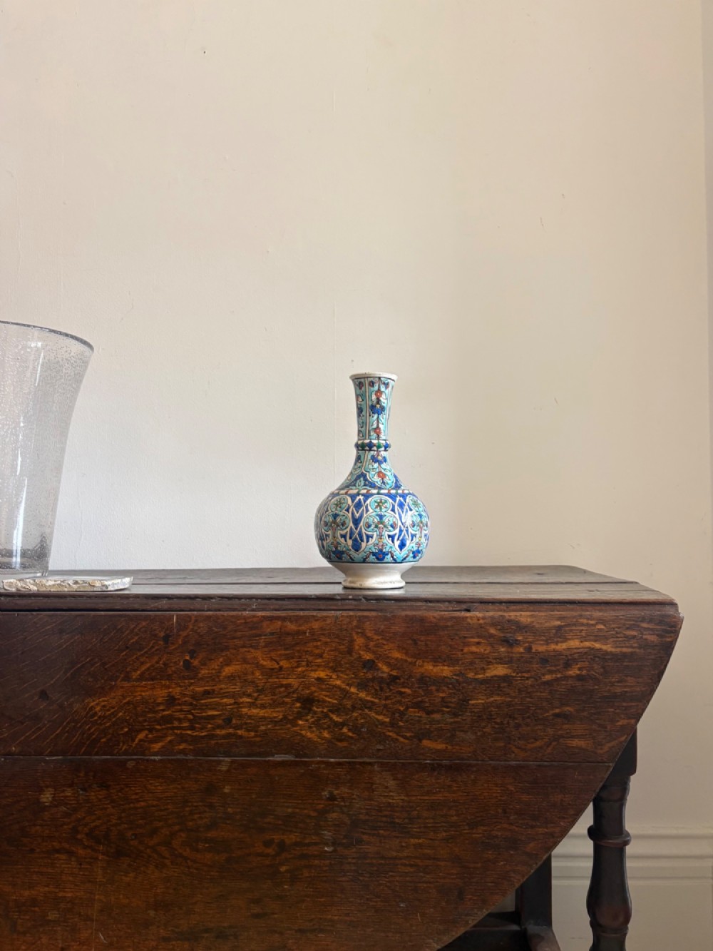 A hand-painted 19th-century Iznik style fritware bottle vase decorated with turquoise, cobalt blue, and red floral arabesque motifs. View III