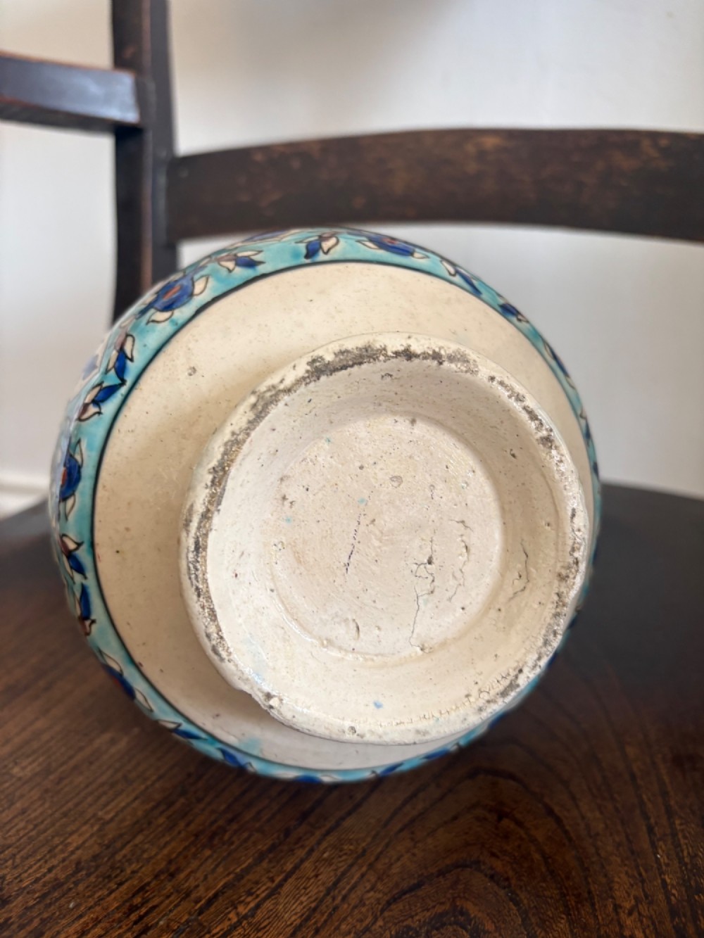A hand-painted 19th-century Iznik style fritware bottle vase decorated with turquoise, cobalt blue, and red floral arabesque motifs. View V