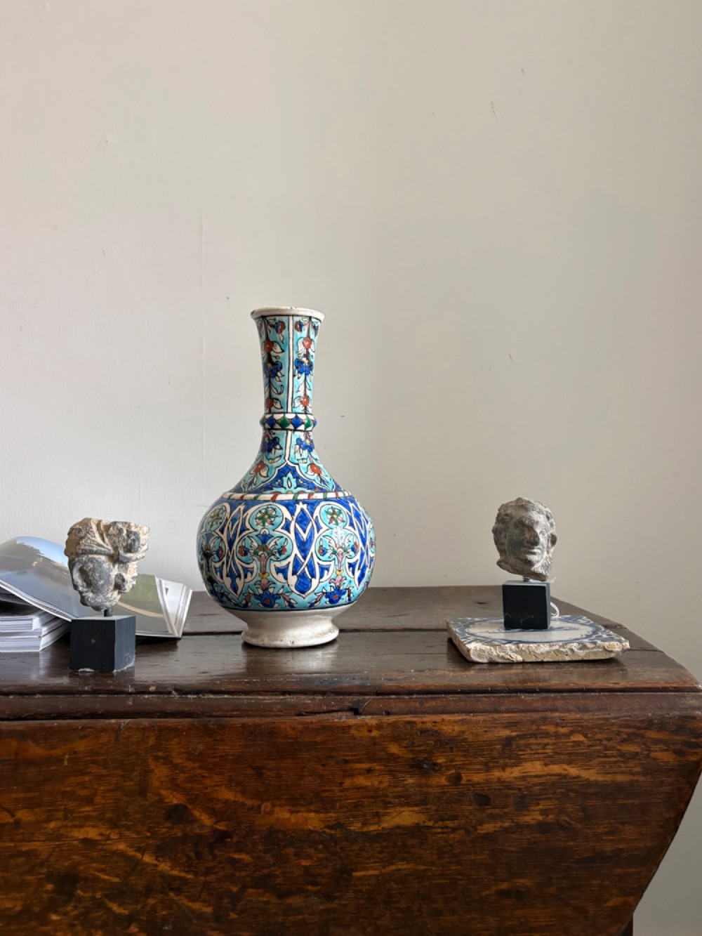 A hand-painted 19th-century Iznik style fritware bottle vase decorated with turquoise, cobalt blue, and red floral arabesque motifs. View VIII