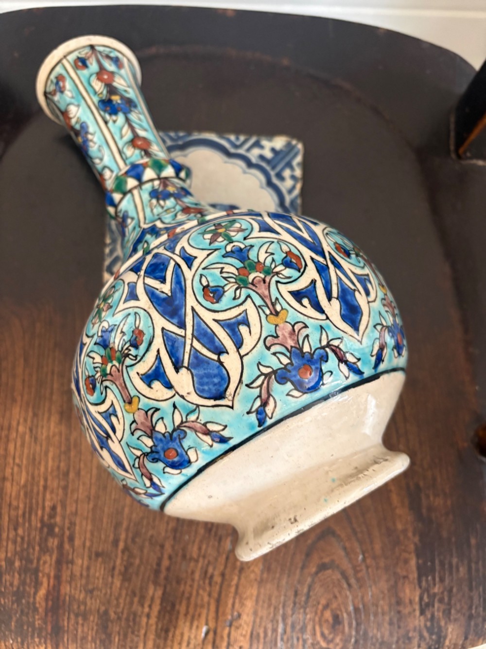 A hand-painted 19th-century Iznik style fritware bottle vase decorated with turquoise, cobalt blue, and red floral arabesque motifs. View XIV