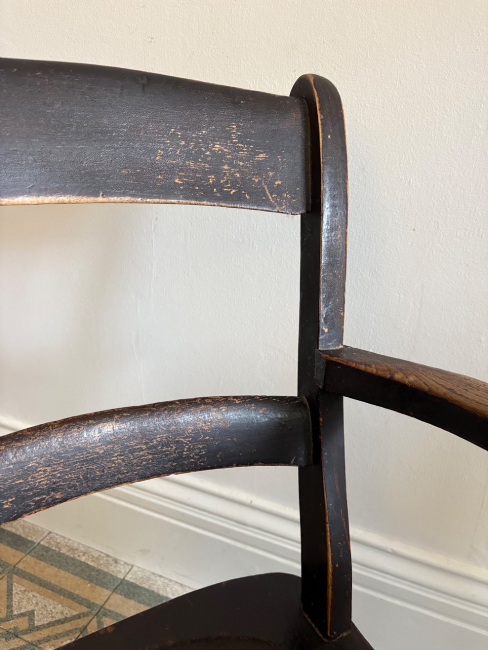A mid-19th-century ebonised Thames Valley Windsor armchair with a slat back, shaped elm seat, and turned wooden legs. View III