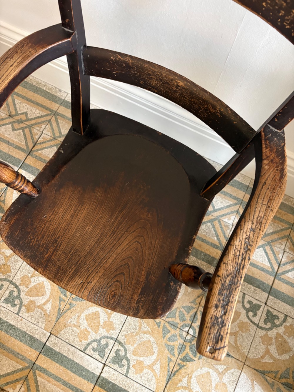 A mid-19th-century ebonised Thames Valley Windsor armchair with a slat back, shaped elm seat, and turned wooden legs. View VIII