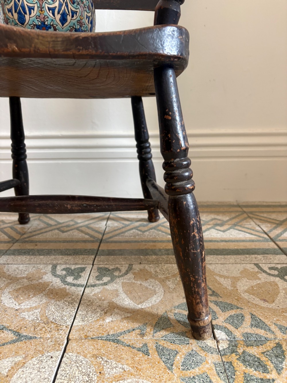 A mid-19th-century ebonised Thames Valley Windsor armchair with a slat back, shaped elm seat, and turned wooden legs. View XI