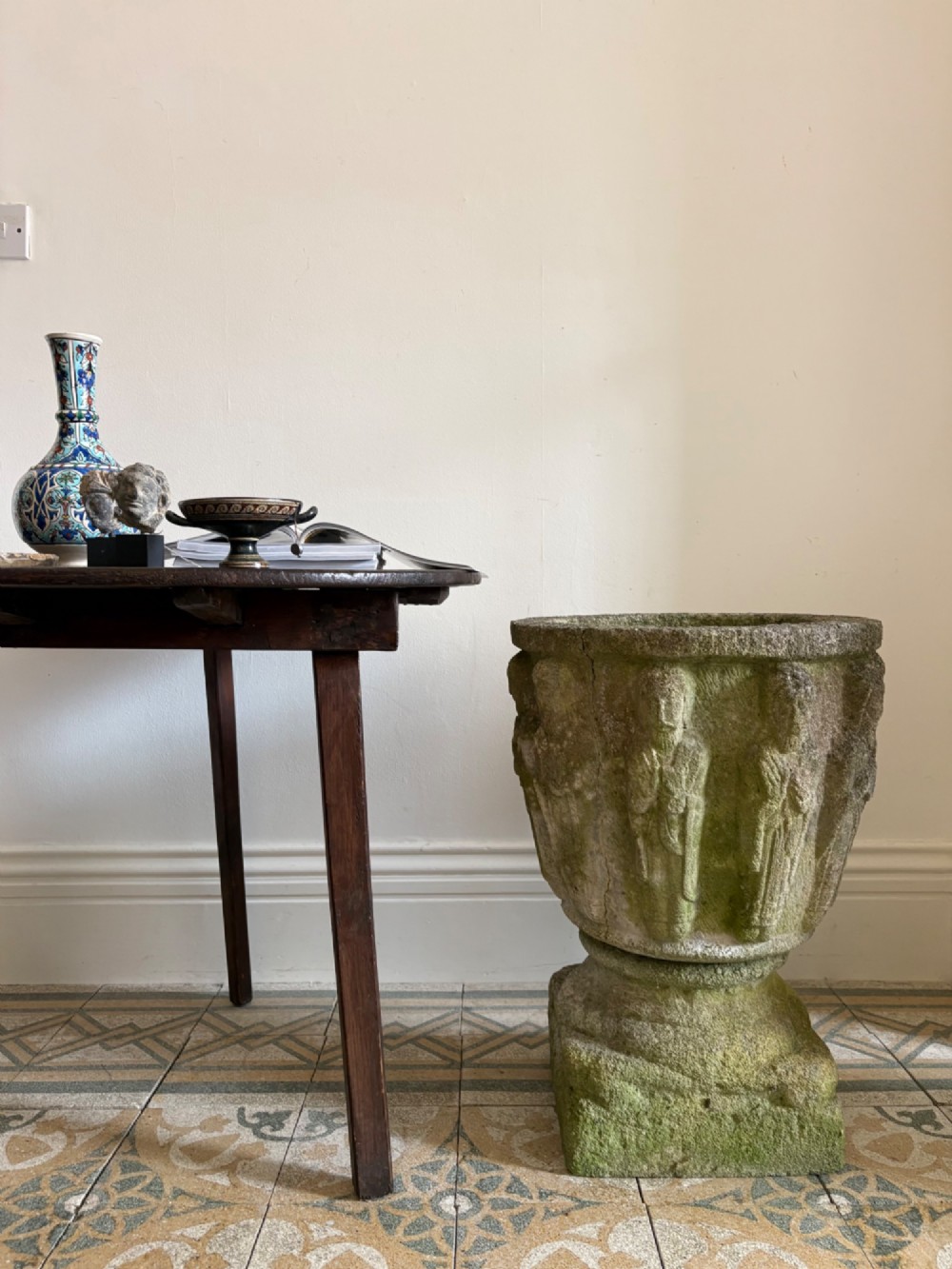 A nineteenth-century round wooden cricket table featuring a circular oak plank top resting on three dark pine legs. View XI