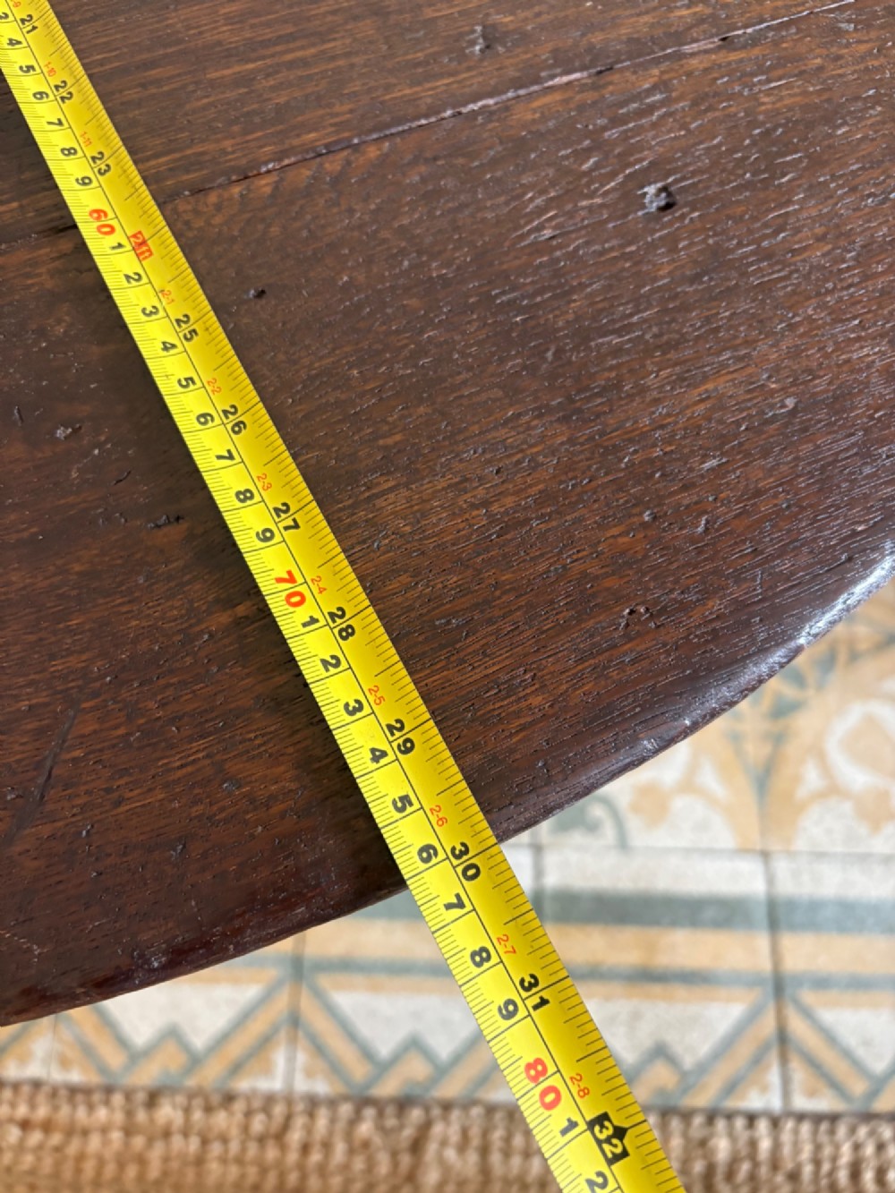 A nineteenth-century round wooden cricket table featuring a circular oak plank top resting on three dark pine legs. View XII
