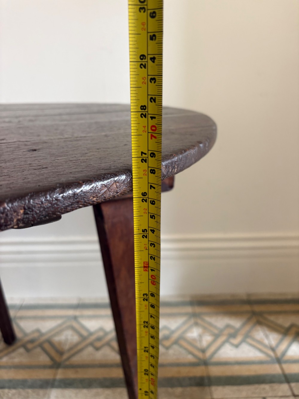 A nineteenth-century round wooden cricket table featuring a circular oak plank top resting on three dark pine legs. View XIII