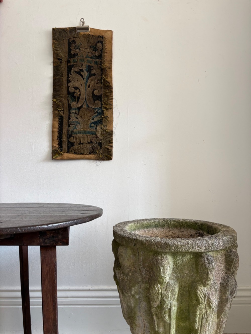 A vertical fragment of an antique hand-woven verdure tapestry featuring acanthus leaf motifs, mounted onto a natural linen backing. View II