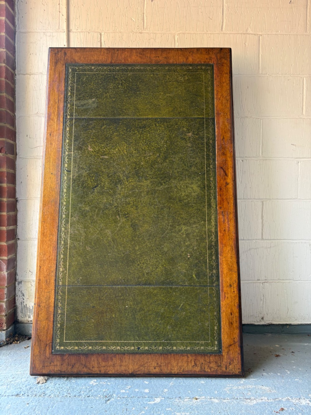 An antique dark mahogany pedestal desk featuring a green leather inset writing top, nine drawers with brass swan-neck handles, and twin pedestals on plinth bases. View II