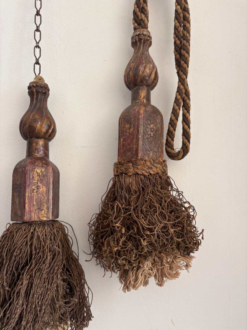 A pair of 19th-century Venetian curtain tiebacks with carved giltwood turned tops and dense fibrous tassels suspended by a chain and cord. View XIII