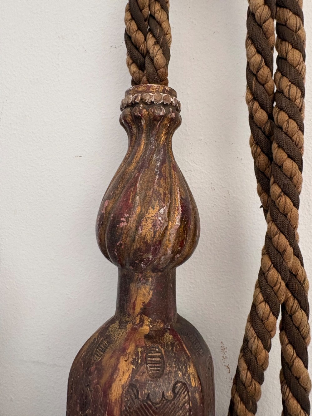 A pair of 19th-century Venetian curtain tiebacks with carved giltwood turned tops and dense fibrous tassels suspended by a chain and cord. View XV