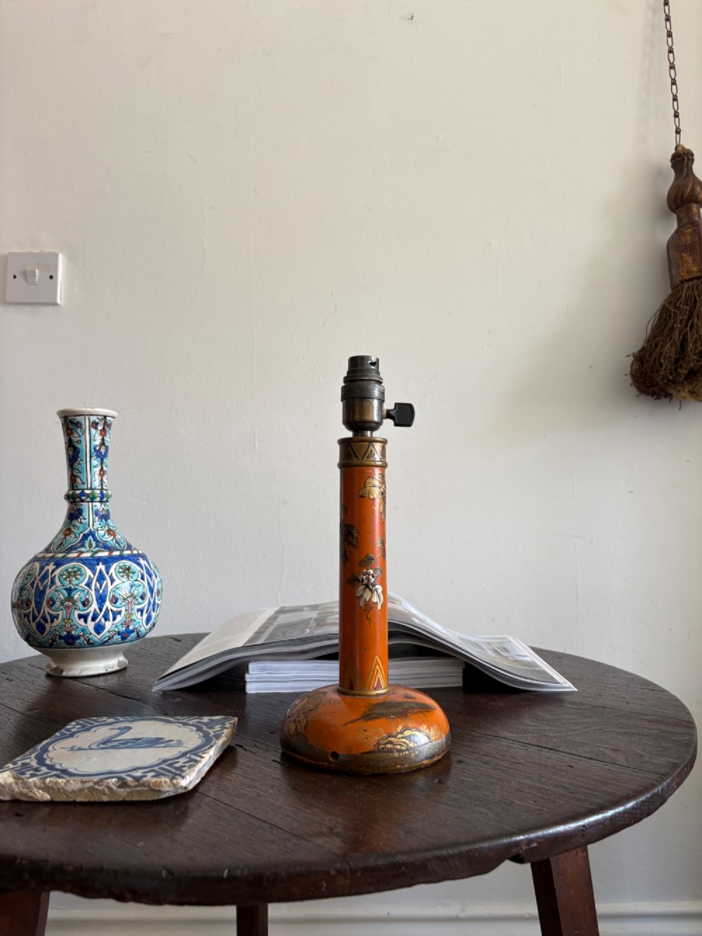 A mandarin orange lacquered table lamp base decorated with gold hand-painted floral motifs and fitted with a brass bulb holder. View VIII