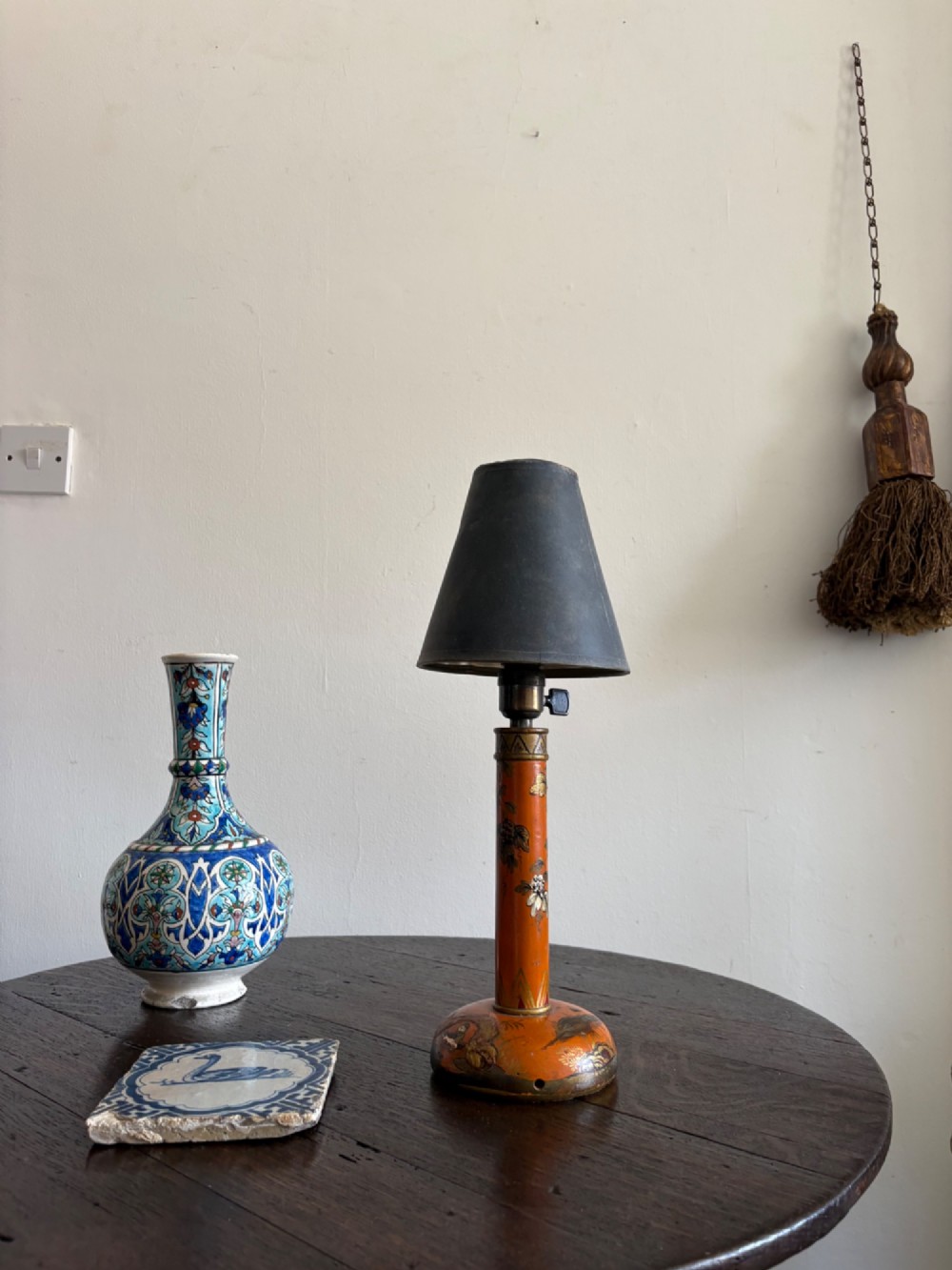 A mandarin orange lacquered table lamp base decorated with gold hand-painted floral motifs and fitted with a brass bulb holder. View XI
