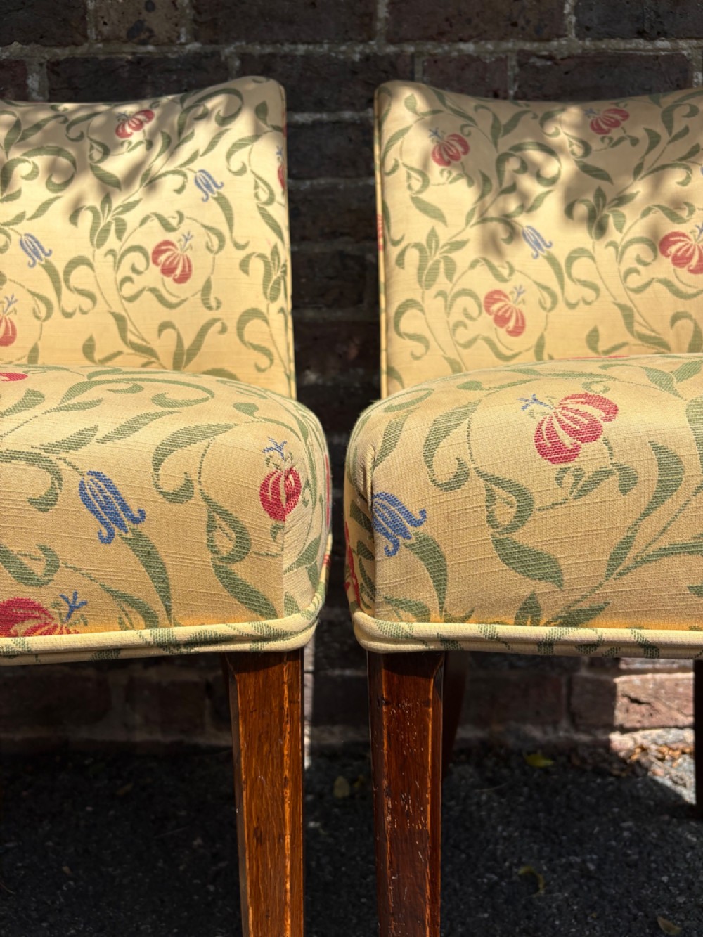 A row of 1930s Art Deco dining chairs featuring yellow floral pattern upholstery and dark oak tapered legs. View III