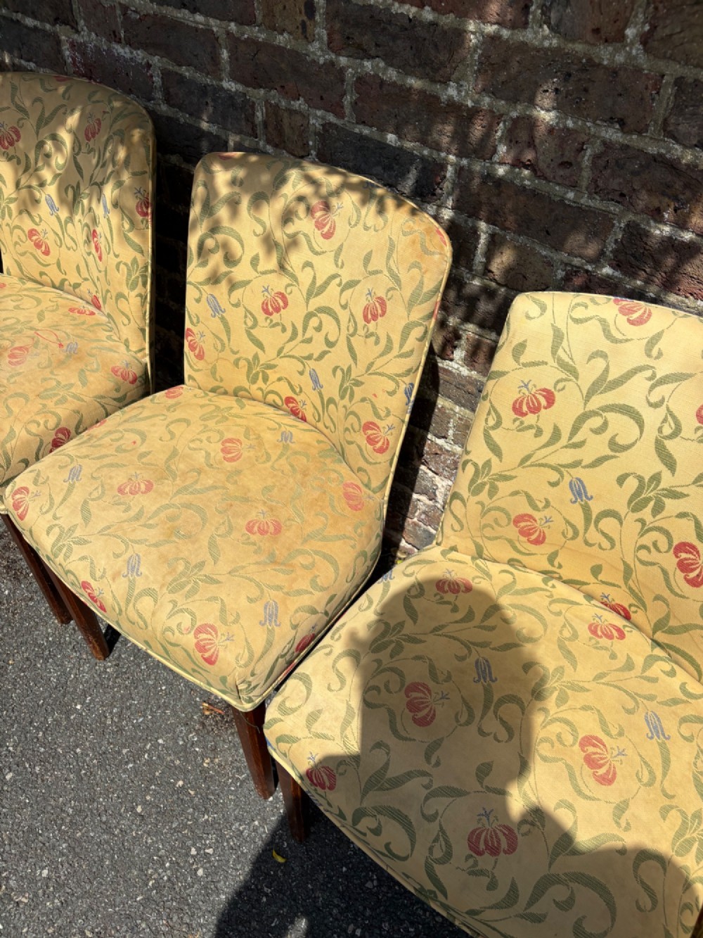 A row of 1930s Art Deco dining chairs featuring yellow floral pattern upholstery and dark oak tapered legs. View VIII