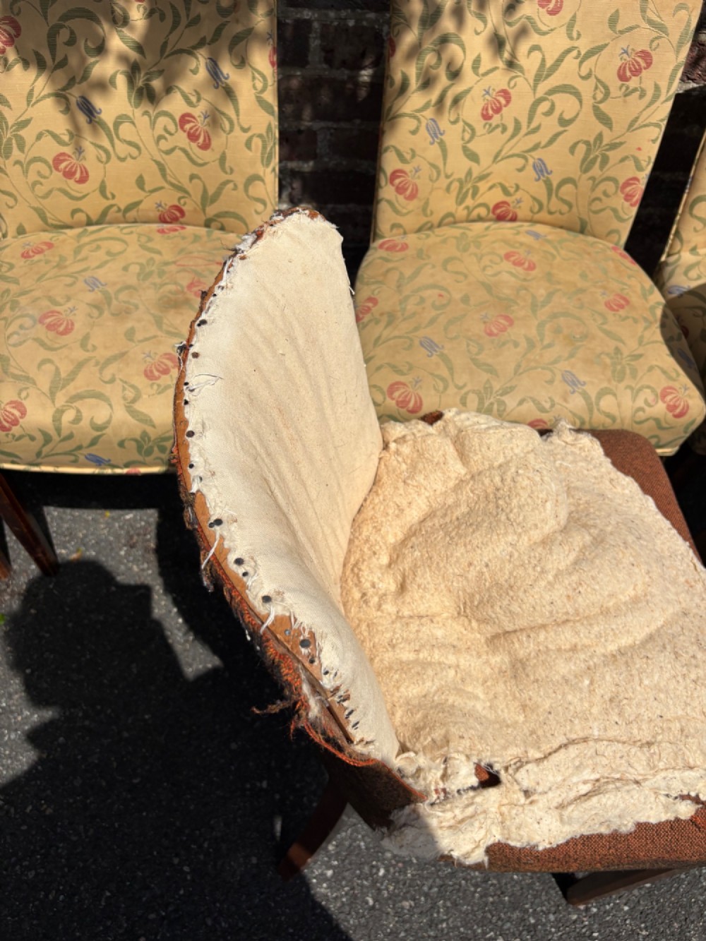 A row of 1930s Art Deco dining chairs featuring yellow floral pattern upholstery and dark oak tapered legs. View XII
