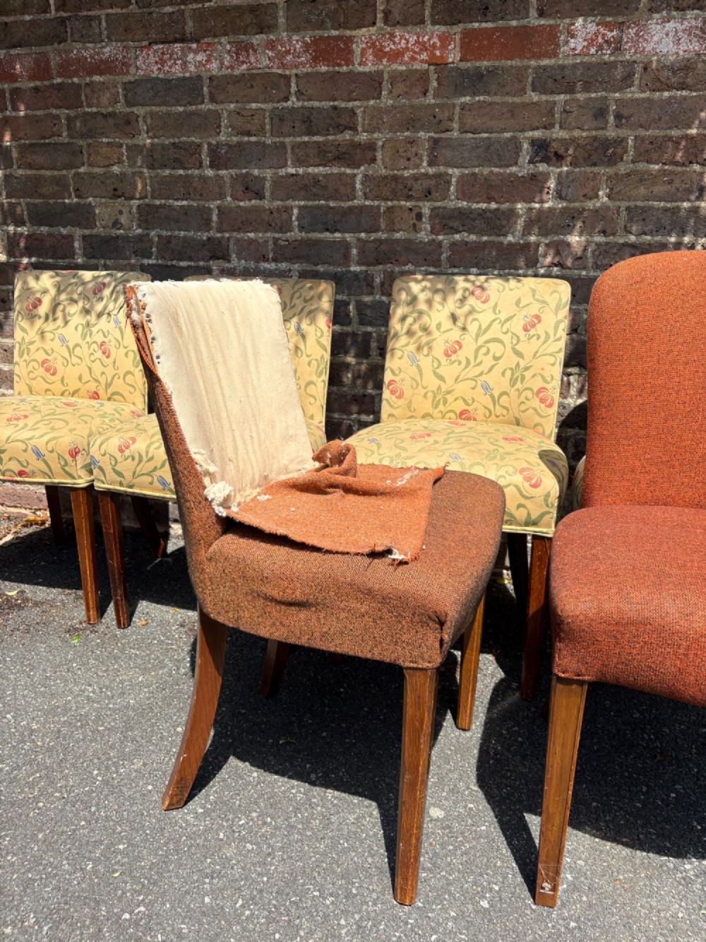 A row of 1930s Art Deco dining chairs featuring yellow floral pattern upholstery and dark oak tapered legs. View XIII